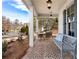 Relaxing front porch includes a seating area and brick flooring, perfect for enjoying the outdoors at 805 Dempsey Ct, Marietta, GA 30064