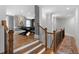 Spacious hallway featuring hardwood floors, staircase with black metal railings, and access to an upstairs room at 805 Dempsey Ct, Marietta, GA 30064