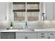 Close up of kitchen featuring stainless steel sink, faucet, stainless steel appliances, white countertops, and natural light at 805 Dempsey Ct, Marietta, GA 30064