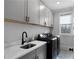 Modern laundry room equipped with a utility sink, washer, dryer, and ample storage space for laundry essentials at 805 Dempsey Ct, Marietta, GA 30064