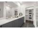 Sleek bathroom with double vanity, quartz countertop, walk-in glass shower, and view to closet at 201 New St # 1102-8, Decatur, GA 30030