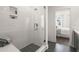 Luxurious tiled shower with glass doors and a view to the main bedroom at 201 New St # 1102-8, Decatur, GA 30030