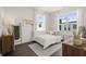 Charming bedroom featuring light walls, gray rug, and a comfortable bed with decorative pillows and a motivational art piece at 201 New St # 1102-8, Decatur, GA 30030