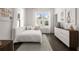 Cozy bedroom with a single bed, plush pillows, dresser, and natural light at 201 New St # 1102-8, Decatur, GA 30030