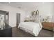 Bright bedroom featuring a bed with a white comforter, neutral furniture and decor at 201 New St # 1102-8, Decatur, GA 30030