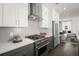 Modern kitchen featuring stainless steel appliances, white countertops and gray cabinets with an open concept view at 201 New St # 1102-8, Decatur, GA 30030