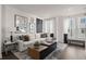 A well-lit living room featuring a comfortable sofa, stylish decor, and large windows at 201 New St # 1102-8, Decatur, GA 30030