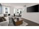 Stylish living room with a comfortable sofa, modern coffee table, and large windows at 201 New St # 1102-8, Decatur, GA 30030