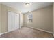 Bedroom featuring neutral walls, carpet floors, and closet with paneled doors at 2248 Asquith Sw Ave, Marietta, GA 30008