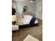 A primary bedroom features a bed with neutral bedding and a navy throw blanket at 746 Great Oak Pl, Villa Rica, GA 30180
