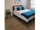 Bedroom features a bed with a grey headboard and side table with decor at 746 Great Oak Pl, Villa Rica, GA 30180