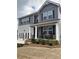 Charming two-story home with a covered front porch and rocking chairs at 746 Great Oak Pl, Villa Rica, GA 30180