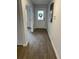 Bright hallway featuring wood-look floors, white walls, and views of the front door at 746 Great Oak Pl, Villa Rica, GA 30180
