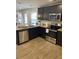 Modern kitchen features stainless steel appliances, granite countertops, and ample storage space at 746 Great Oak Pl, Villa Rica, GA 30180