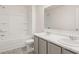 Bathroom showcasing double sinks, a large mirror, toilet, and bathtub with tiled walls at 165 Aster Avenue, Locust Grove, GA 30248