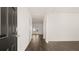 Hallway featuring modern wood floors and white walls at 165 Aster Avenue, Locust Grove, GA 30248