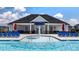 Close-up of community pool featuring a splash fountain, lounge seating, and the clubhouse at 165 Aster Avenue, Locust Grove, GA 30248