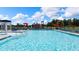 Resort-style community pool view, including a splash fountain, lounge chairs, umbrellas, and a playground at 165 Aster Avenue, Locust Grove, GA 30248