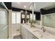 Modern bathroom features double sinks, a large mirror, and a glass-enclosed shower at 18 Brandon Ridge Dr, Sandy Springs, GA 30328