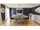 Elegant dining room with dark blue walls, hardwood floors, stylish lighting, and built-in cabinets at 18 Brandon Ridge Dr, Sandy Springs, GA 30328