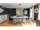 Elegant dining room with hardwood floors, stylish lighting, dark blue accent walls, and decorative wall art at 18 Brandon Ridge Dr, Sandy Springs, GA 30328