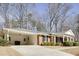 Traditional-style home featuring an attached carport, brick facade, and a well-maintained front lawn at 18 Brandon Ridge Dr, Sandy Springs, GA 30328