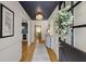 Welcoming hallway featuring hardwood floors, a decorative light fixture, and stylish decor, leading to other rooms at 18 Brandon Ridge Dr, Sandy Springs, GA 30328