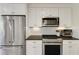 Modern kitchen with stainless steel appliances, ample counter space, and white subway tile backsplash at 18 Brandon Ridge Dr, Sandy Springs, GA 30328