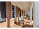 Inviting brick front porch featuring classic rocking chairs and brick columns, creating a cozy and welcoming entrance at 18 Brandon Ridge Dr, Sandy Springs, GA 30328