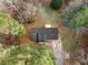 Aerial view of house showcasing roof, driveway, and surrounding landscape of mature trees and natural beauty at 247 Mandy Ct, Mcdonough, GA 30252