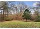 A large, grassy backyard with mature trees offering privacy and natural beauty at 247 Mandy Ct, Mcdonough, GA 30252