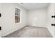 Carpeted bedroom featuring a window that provides natural light and neutral walls at 247 Mandy Ct, Mcdonough, GA 30252