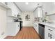 Modern kitchen with white cabinets, quartz countertops, and stainless steel appliances at 247 Mandy Ct, Mcdonough, GA 30252