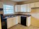 Kitchen featuring white cabinetry, a double stainless-steel sink, and modern appliances at 2736 Claire Ter, Decatur, GA 30032