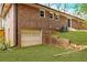 Backyard view with a garage and grassy slope at 3020 Norton Se Ct, Smyrna, GA 30082