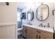 Beautiful bathroom with a double sink vanity, matching mirrors, modern lighting, and gorgeous blue tile at 3020 Norton Se Ct, Smyrna, GA 30082