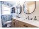 Bright bathroom featuring a modern vanity, dual mirrors, and stylish blue wall tiles offering a spa-like ambiance at 3020 Norton Se Ct, Smyrna, GA 30082