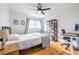 Relaxing bedroom with wood floors, a ceiling fan, natural light, and a dedicated desk and bookshelf area at 3020 Norton Se Ct, Smyrna, GA 30082