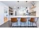 Charming kitchen featuring bar seating, modern pendant lighting, and floating shelves at 3020 Norton Se Ct, Smyrna, GA 30082