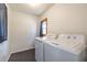 Bright laundry room with a tile floor, washer, and dryer at 3020 Norton Se Ct, Smyrna, GA 30082