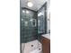 Modern shower with sleek glass doors, gold fixtures, and stylish green tiling, creating a spa-like atmosphere at 3020 Norton Se Ct, Smyrna, GA 30082