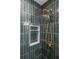 Elegant shower featuring vertical green tile and modern bronze fixtures at 3020 Norton Se Ct, Smyrna, GA 30082