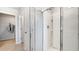 Bright bathroom featuring glass shower with white tiles, silver fixtures and walk-in closet at 509 Vervain Drive, Locust Grove, GA 30248