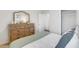 Well-lit bedroom featuring wood dresser, neutral colors, and a large window at 509 Vervain Drive, Locust Grove, GA 30248