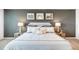 Beautiful bedroom features a king size bed with white bedding and gray accent wall at 509 Vervain Drive, Locust Grove, GA 30248