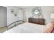 A neutral bedroom features decor above the dresser and an entry to an adjoining room at 509 Vervain Drive, Locust Grove, GA 30248