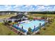 Aerial view of a community pool with seating and umbrellas, with a playground nearby at 509 Vervain Drive, Locust Grove, GA 30248