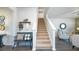 Inviting foyer with staircase, bench seating, and stylish decor creates a welcoming entrance at 509 Vervain Drive, Locust Grove, GA 30248