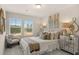 Cozy bedroom with ample light, comfy chair, decorative pillows and stylish mirrored nightstand at 674 Sundial Ln, Mableton, GA 30126