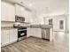 Modern kitchen featuring stainless steel appliances and a granite countertop island at 674 Sundial Ln, Mableton, GA 30126